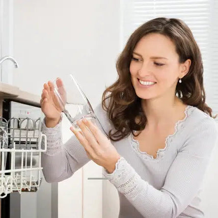 person examining glasses from dishwasher HydroFLOW Canada